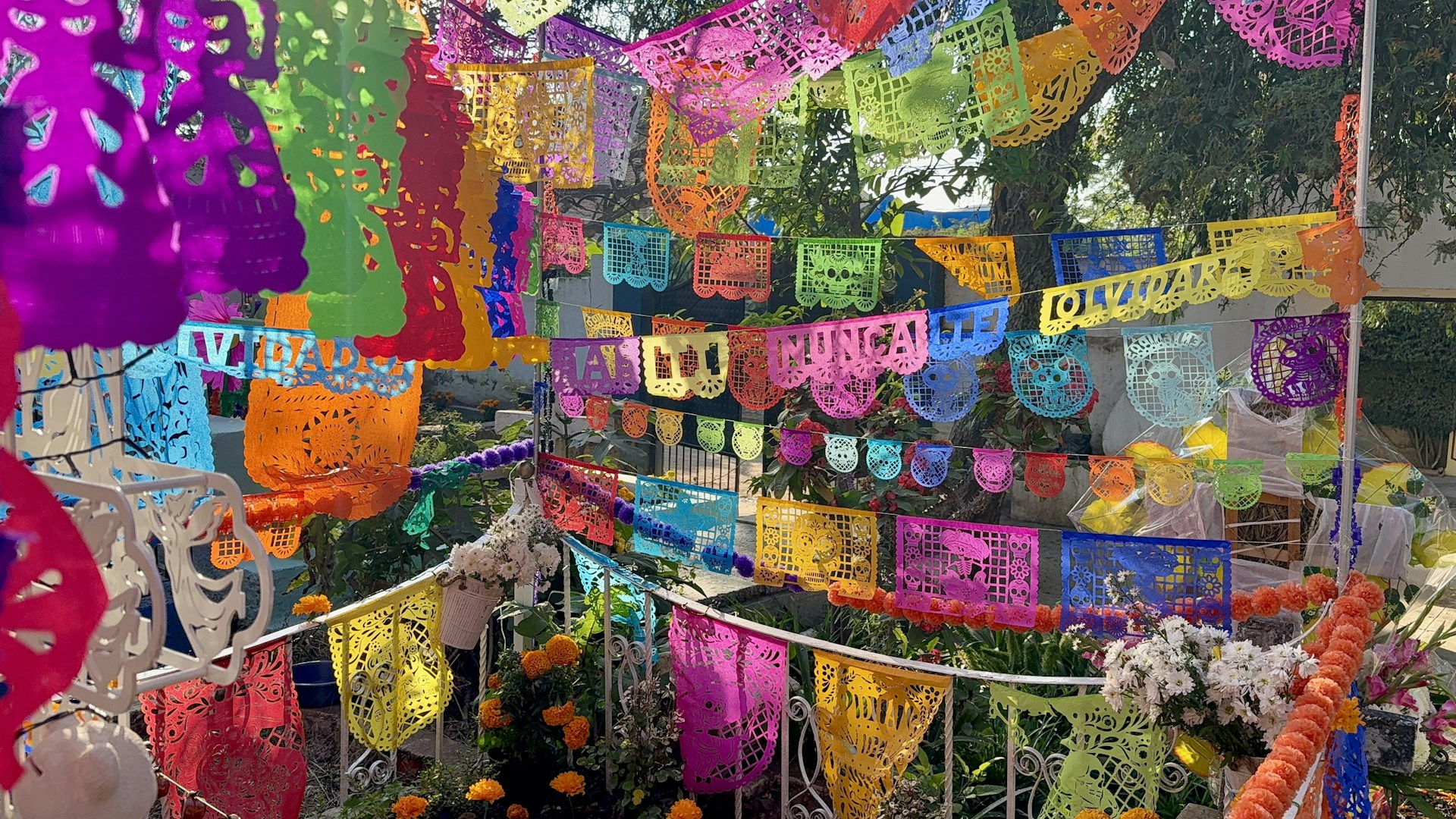 Colorful papel picado banners strung across outdoor space