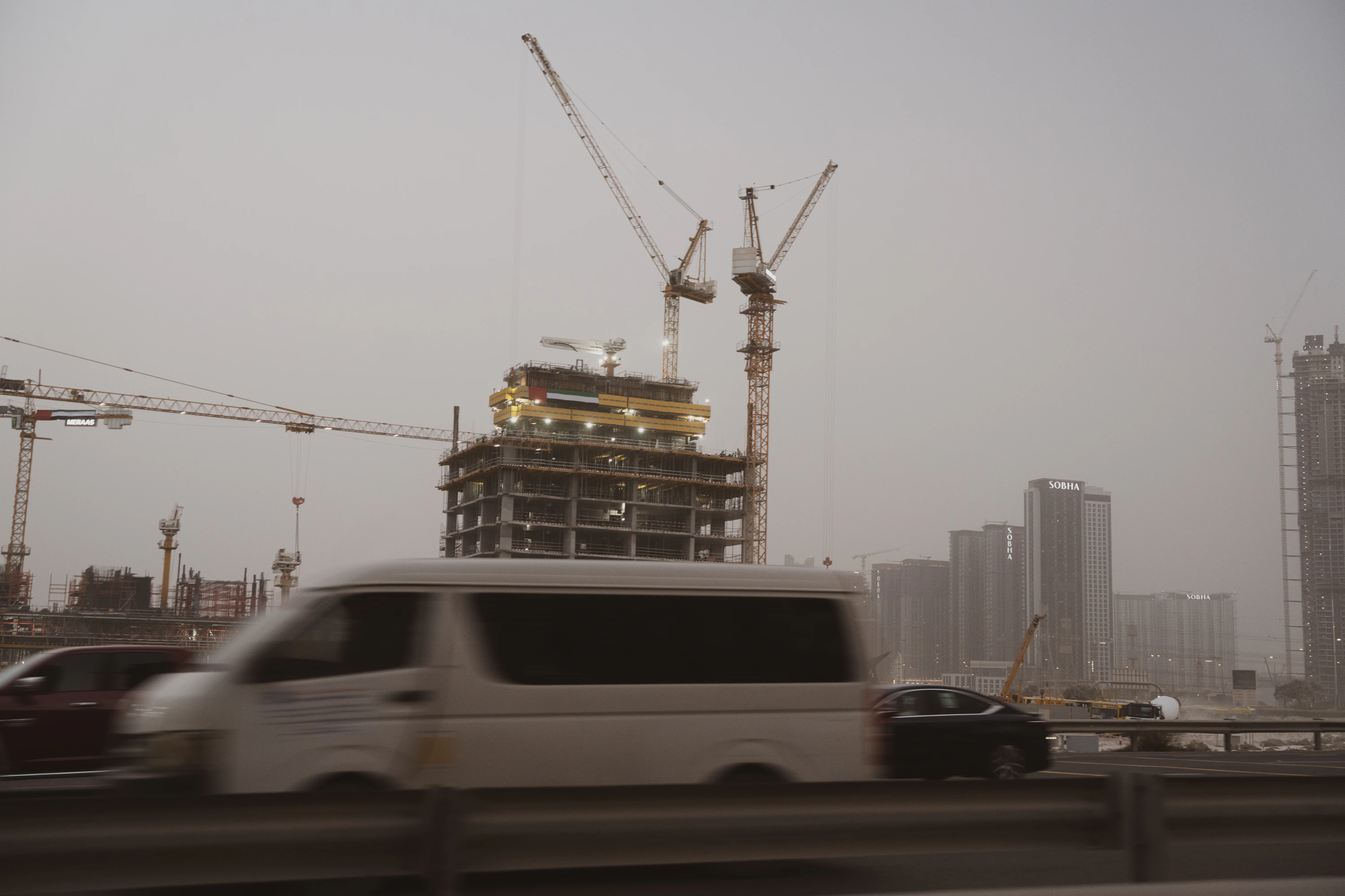 Construction cranes and new high-rise developments across the Dubai skyline