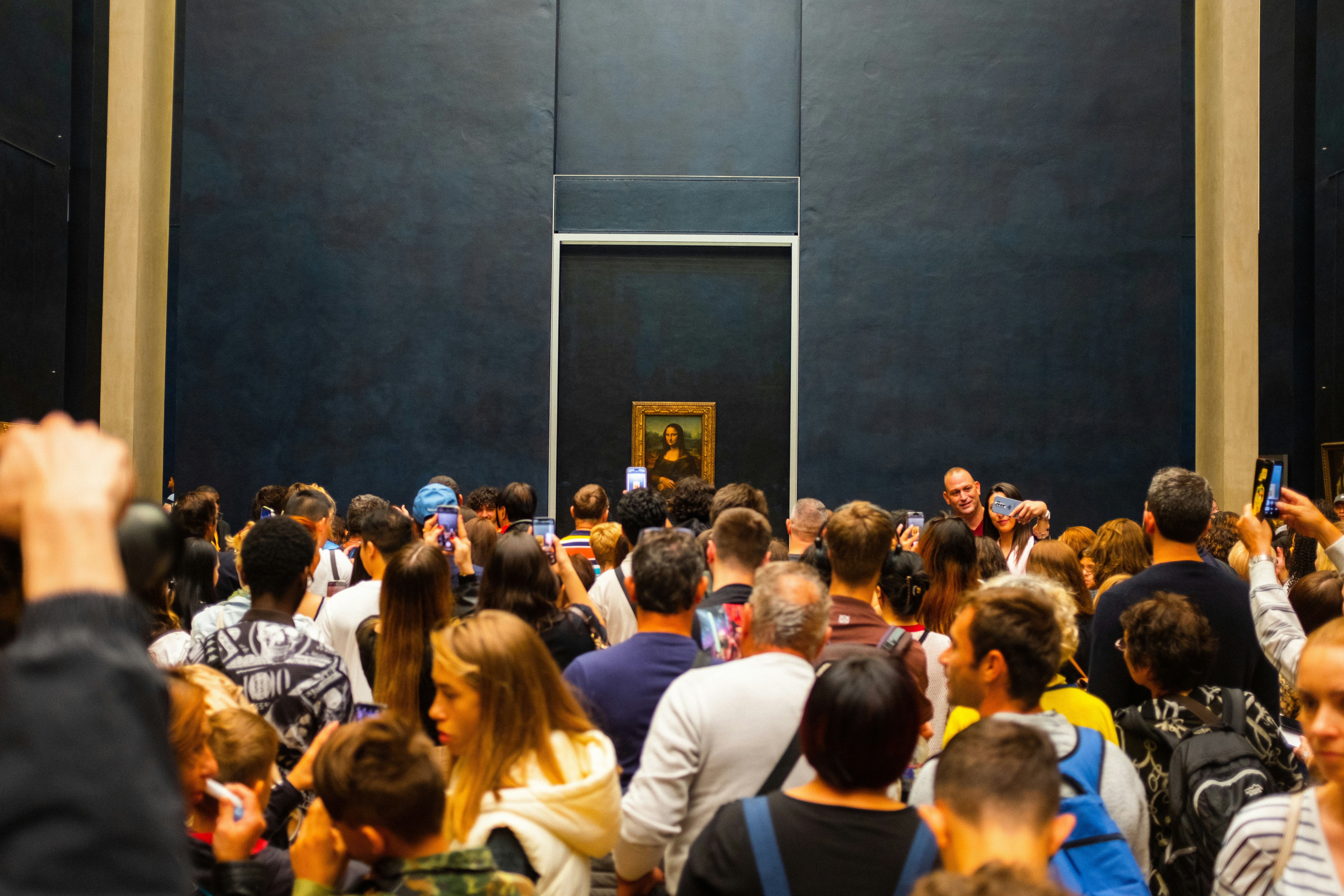 Crowd gathered to see mona lisa painting in museum