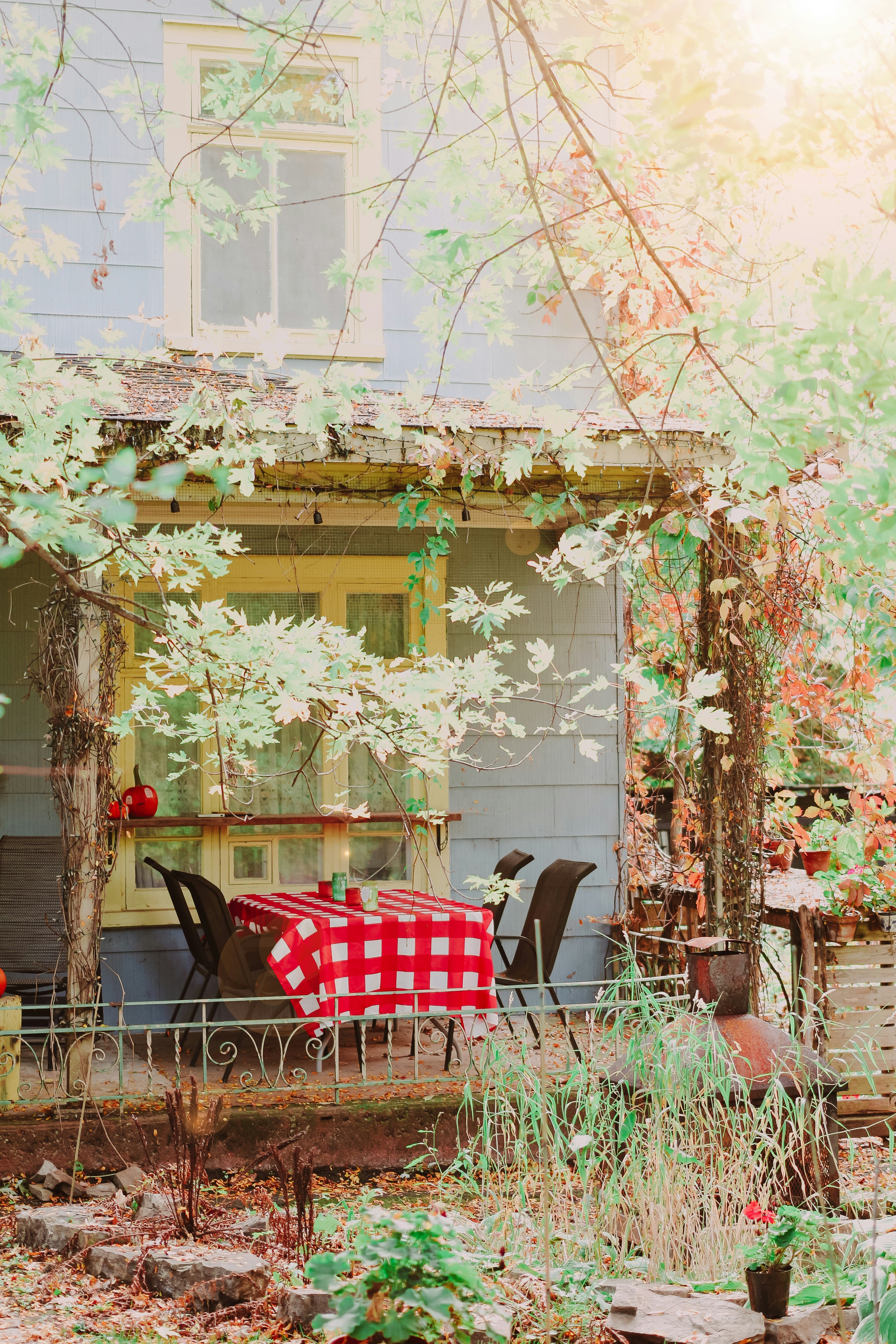 Porch with red checkered tablecloth and chairs