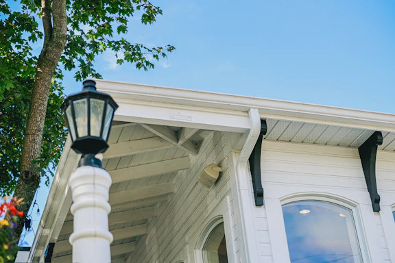 White building with black accents and a lamp post.