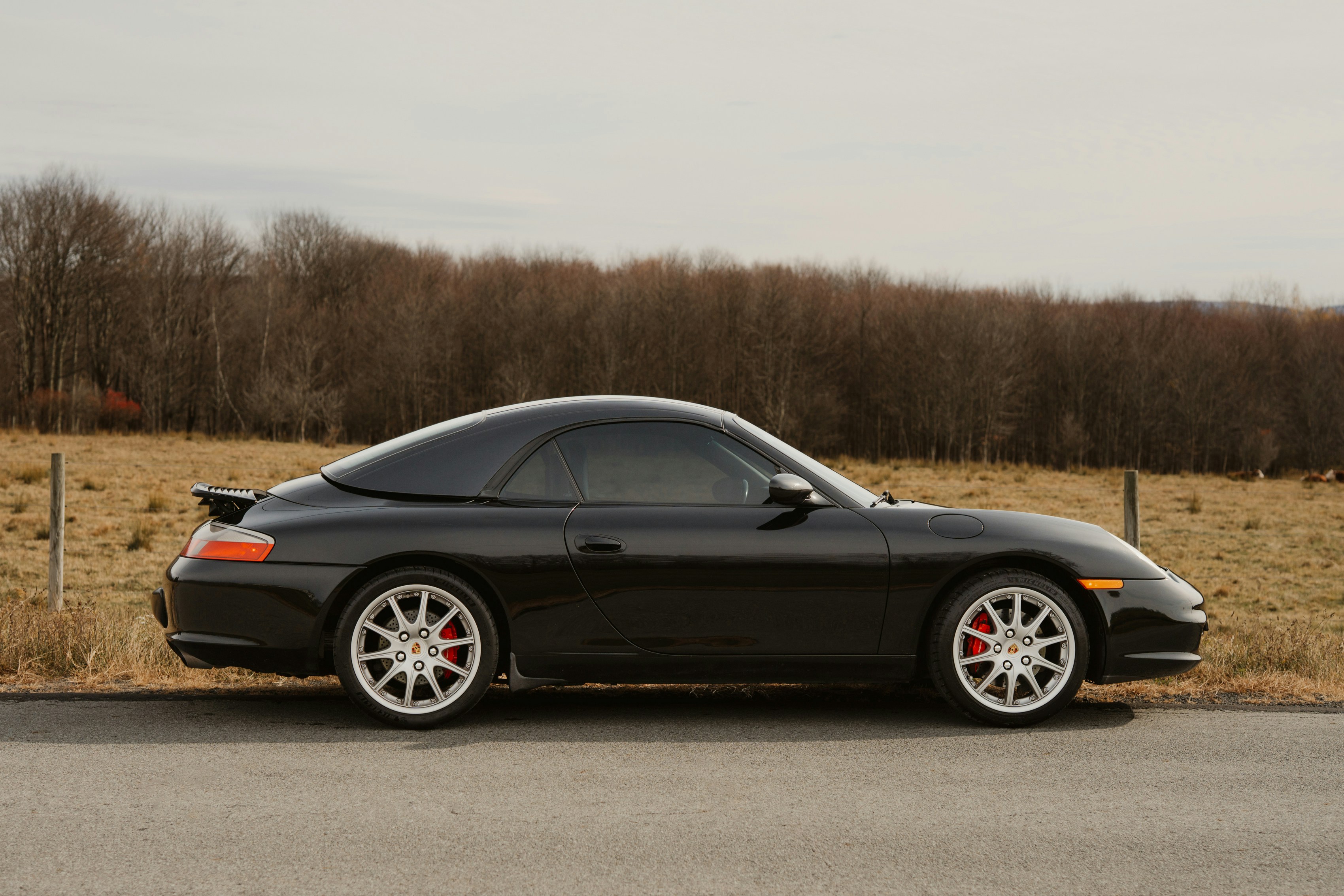 Black porsche targa parked on a rural road
