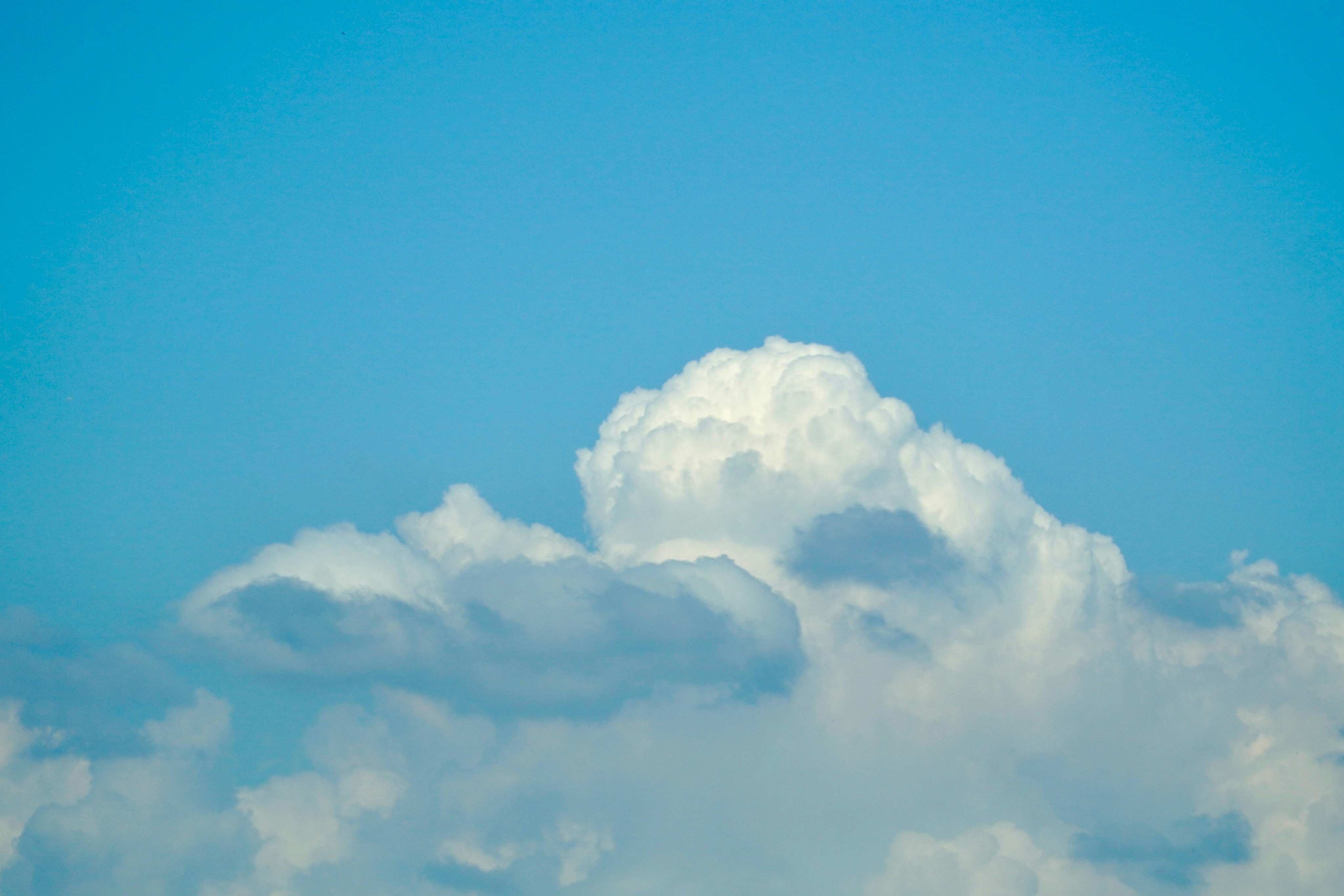 Fluffy white clouds against a clear blue sky
