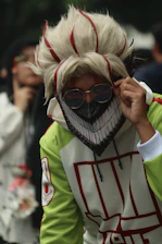 Person in costume with a mask and sunglasses