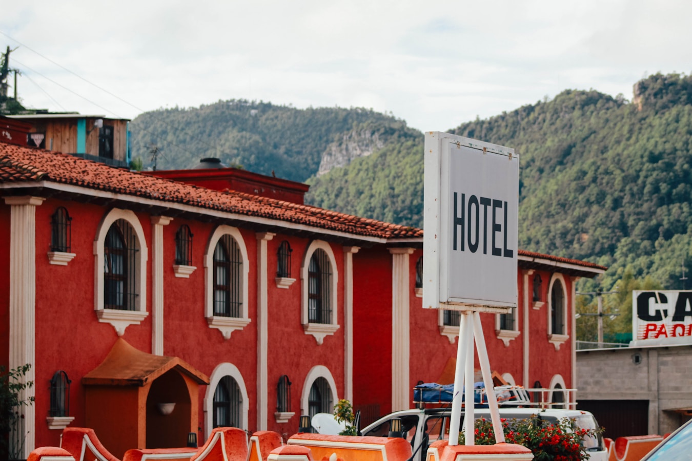 Red hotel building with mountains in background