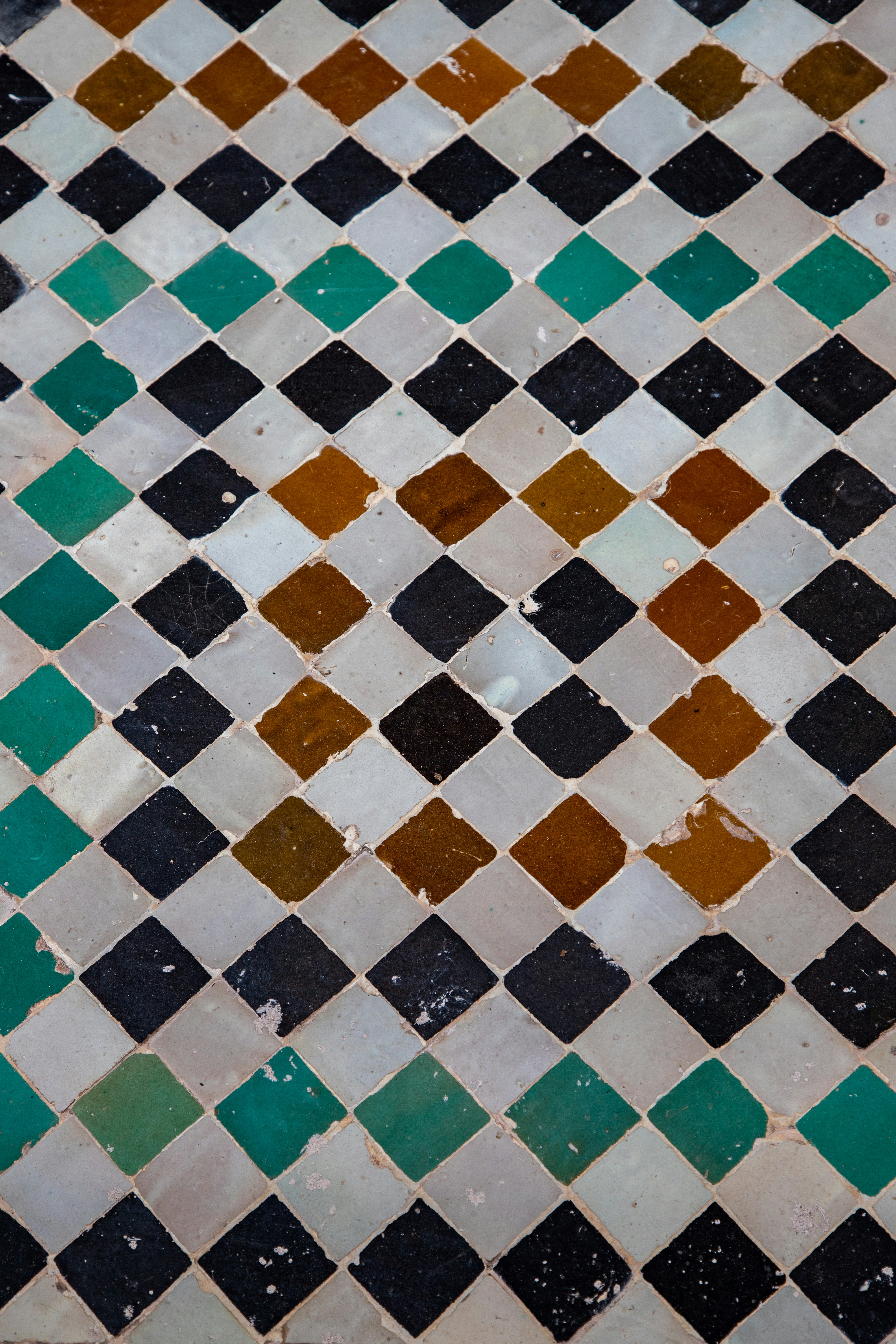 Diamond pattern tiles with green, brown, and black colors.