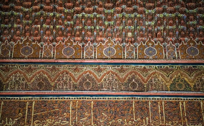 Arabic calligraphy and geometric zellige tilework in Marrakech