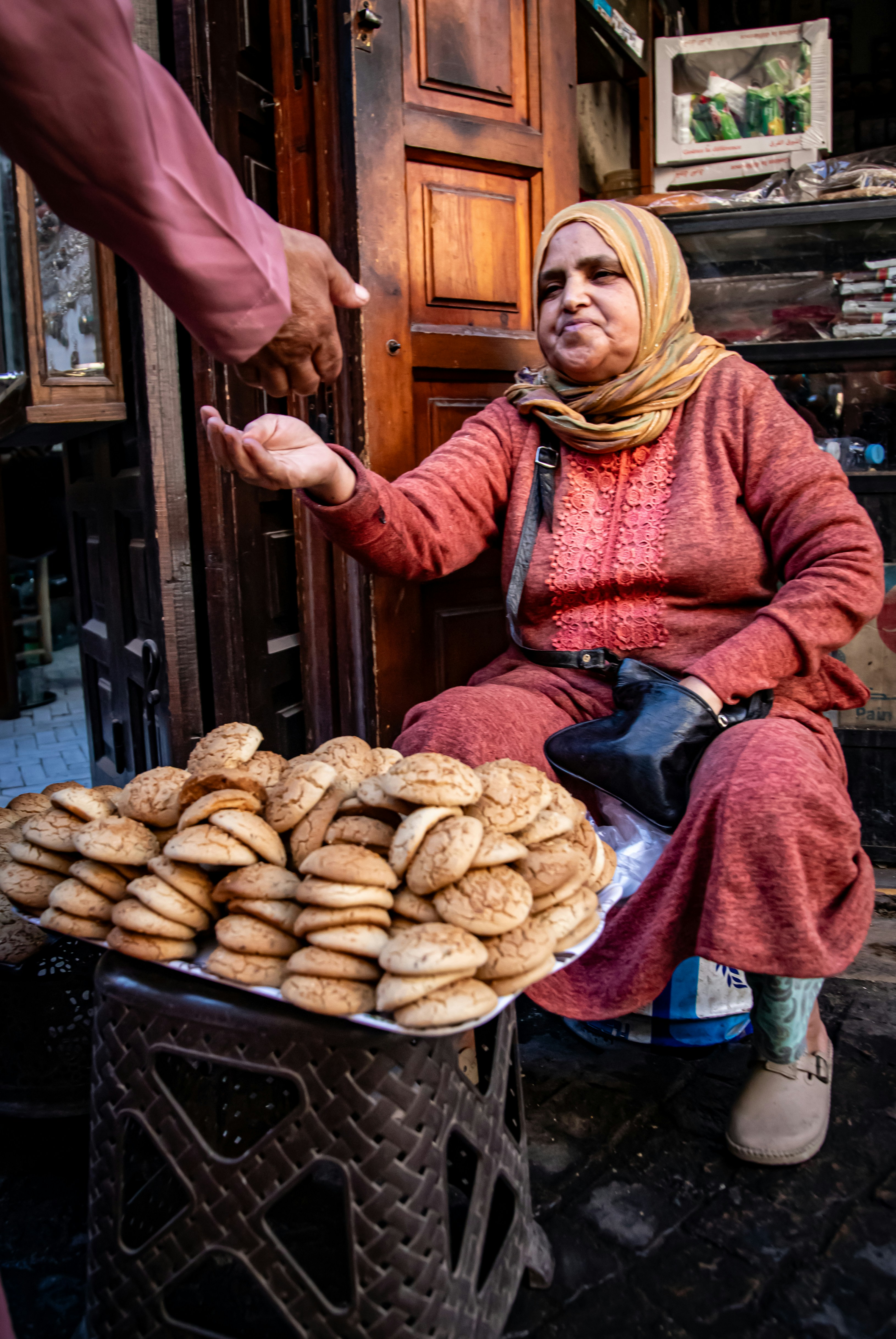 Woman selling cookies from a tray