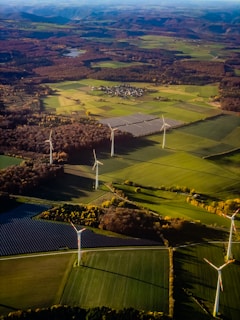 Wind turbines and solar panels in a rural landscape.