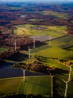 Wind turbines and solar panels in a rural landscape.