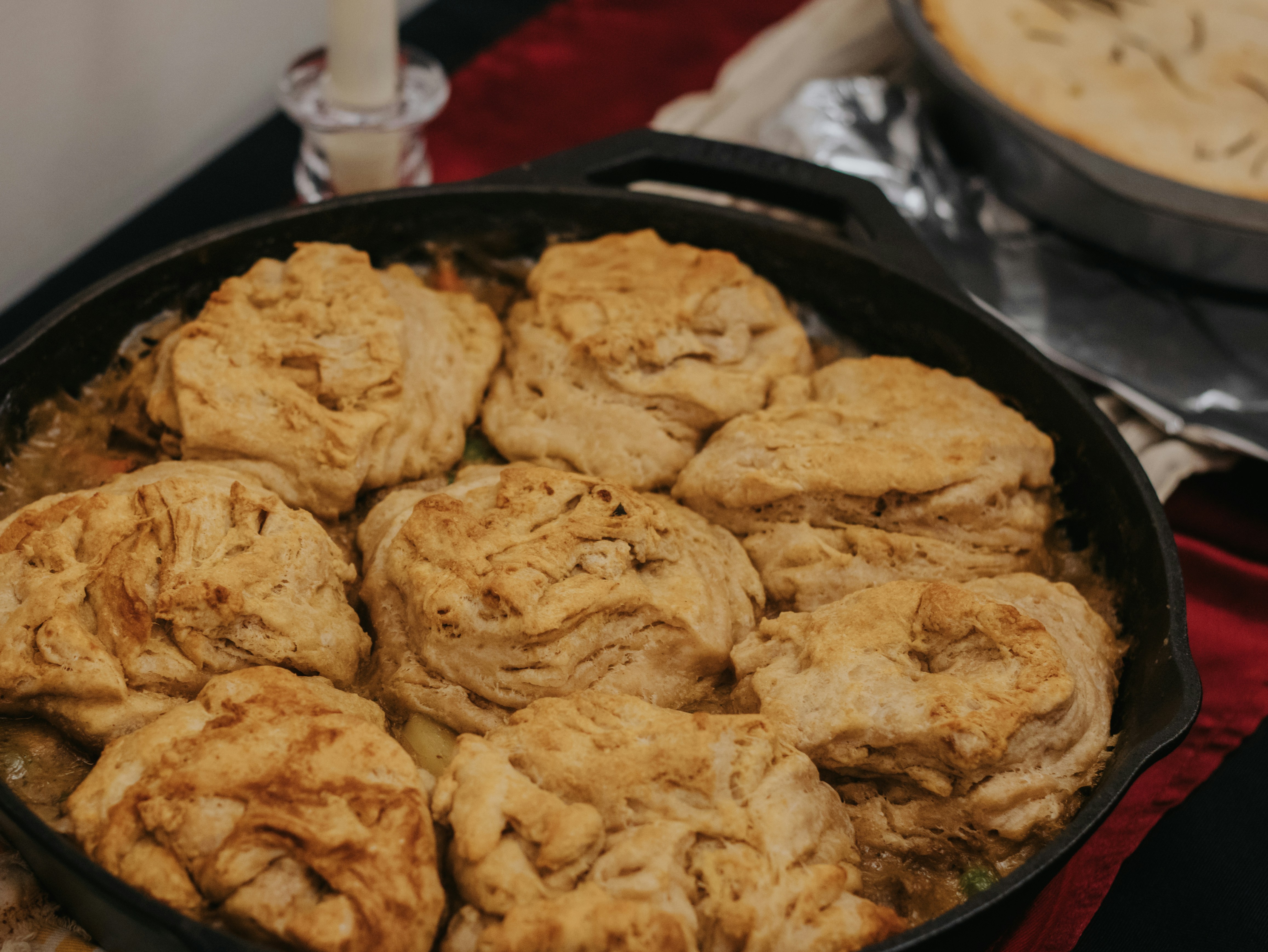 Golden brown biscuits baked in a cast iron skillet.