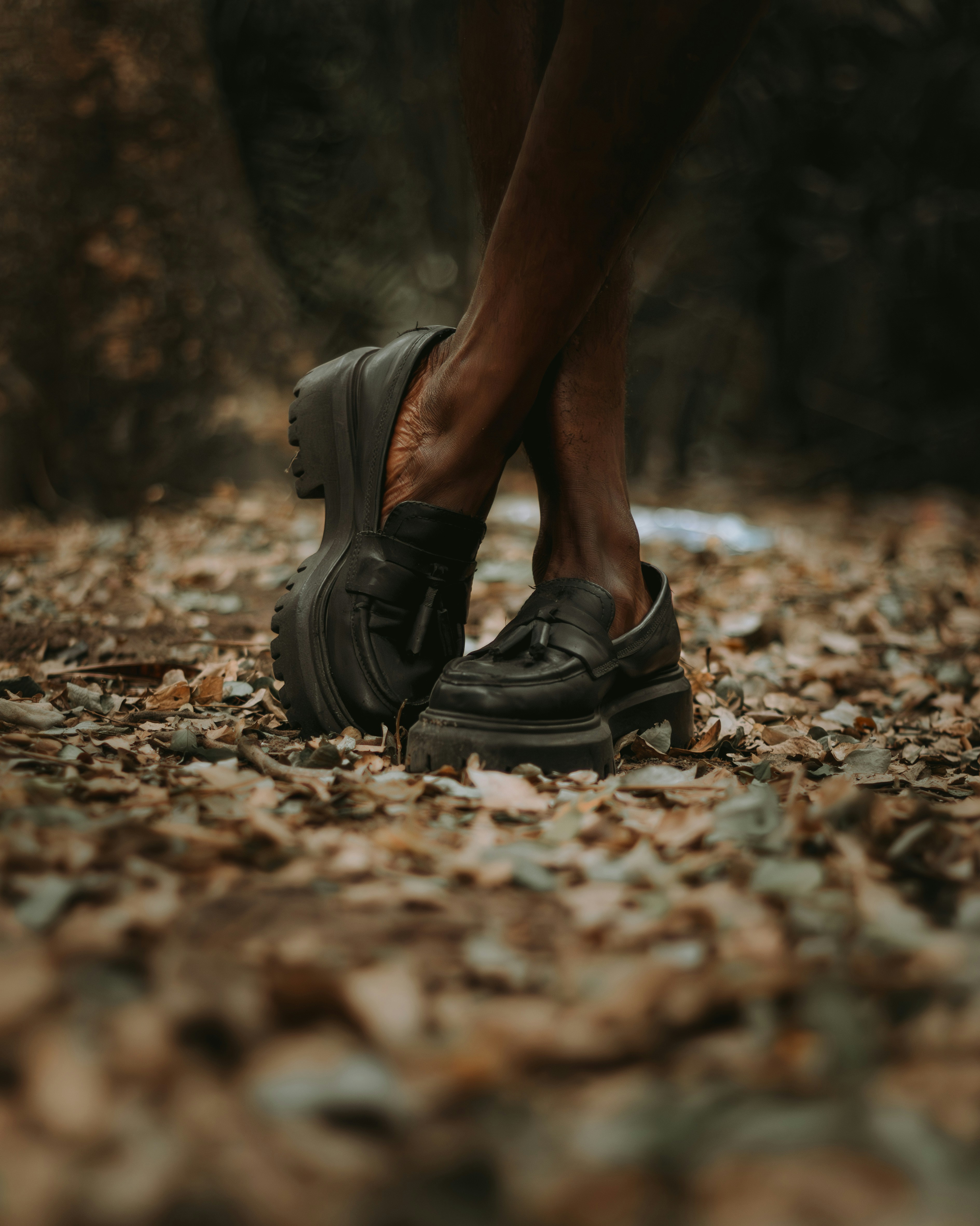 Black loafers with tassels on a person's feet