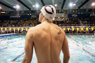 Swimmer with cupping marks on back at pool