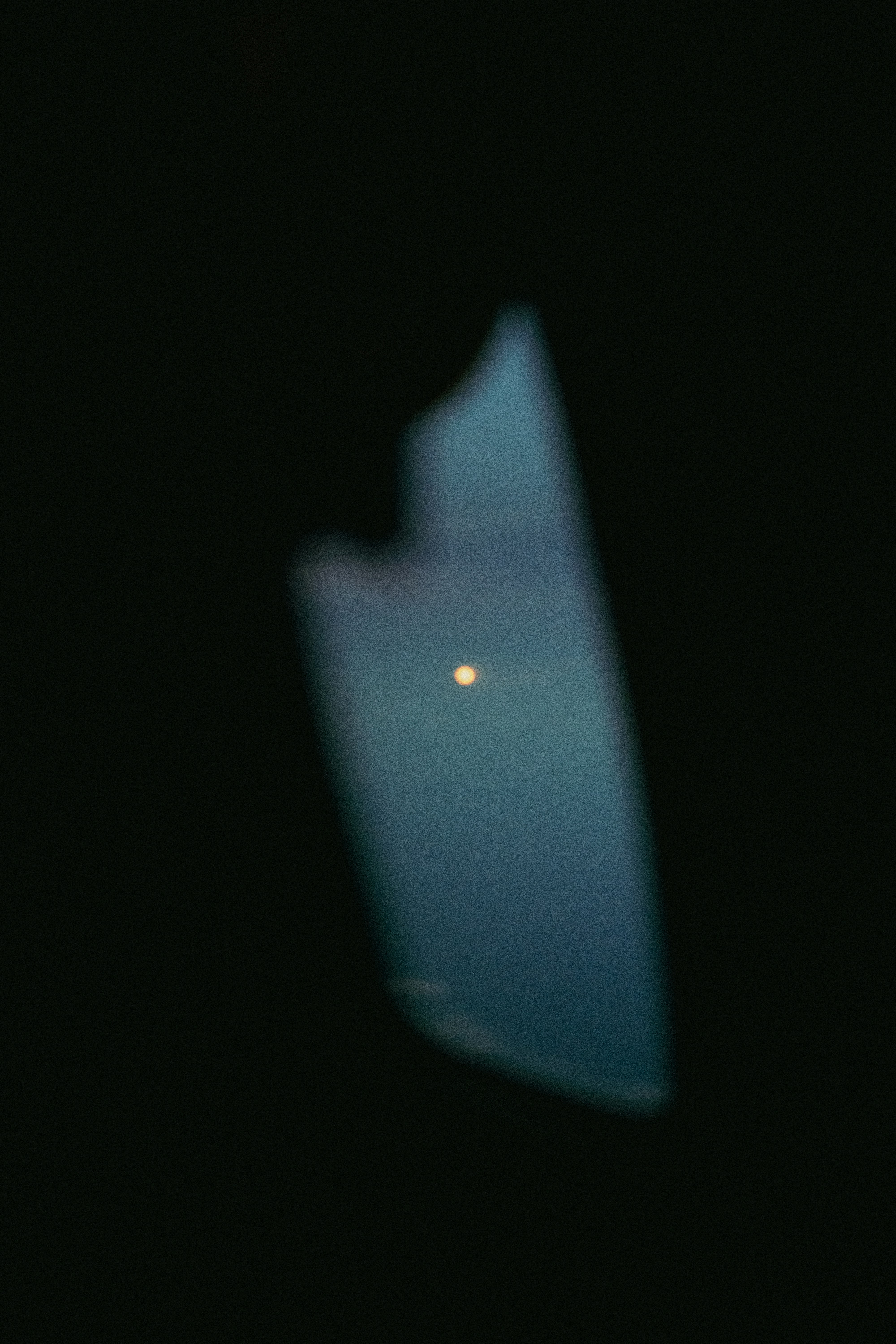 Blurred view of a bright moon in dark sky