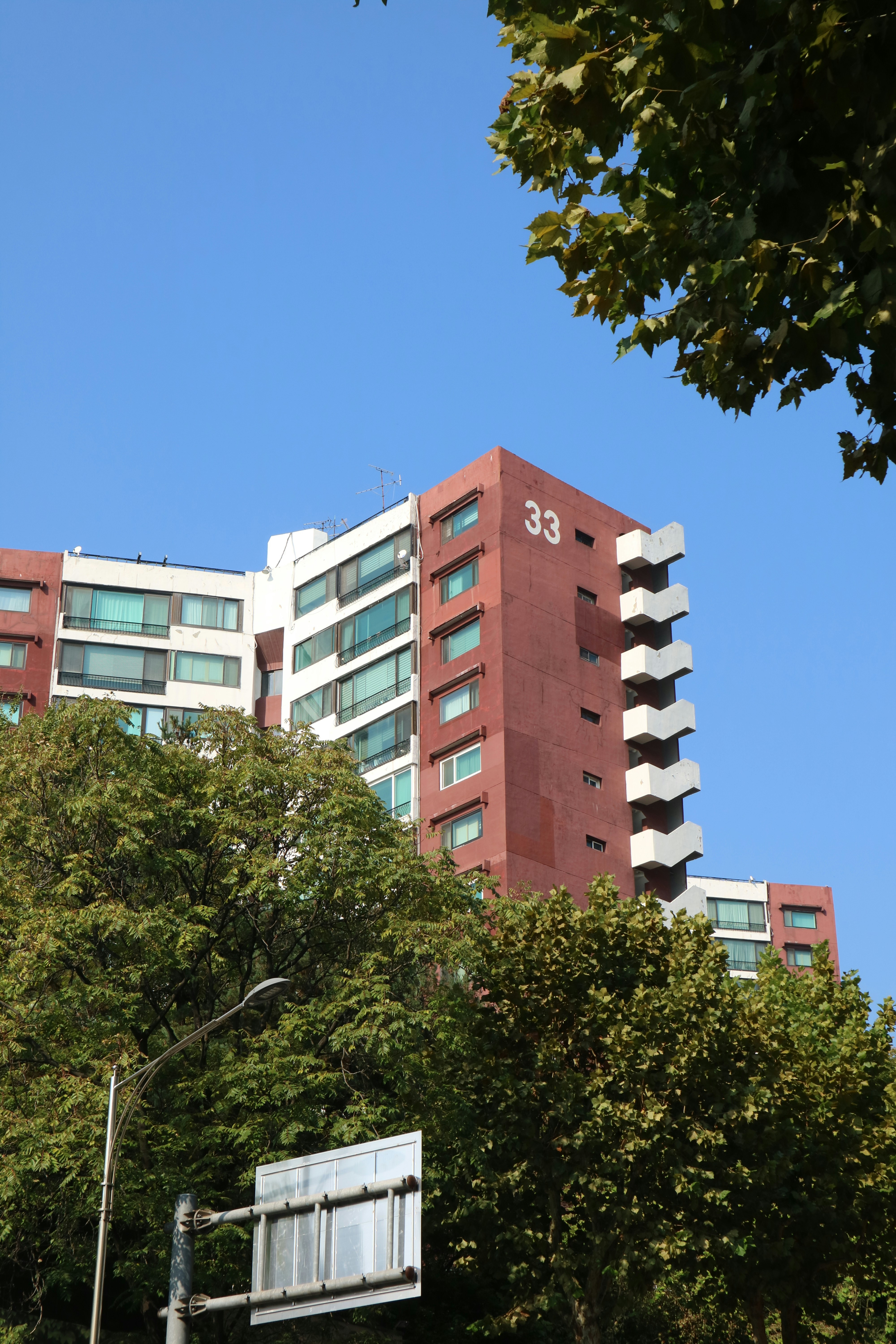 Ein stilvolles, modernes Mehrfamilienhaus mit Balkonen und grüner Umgebung.