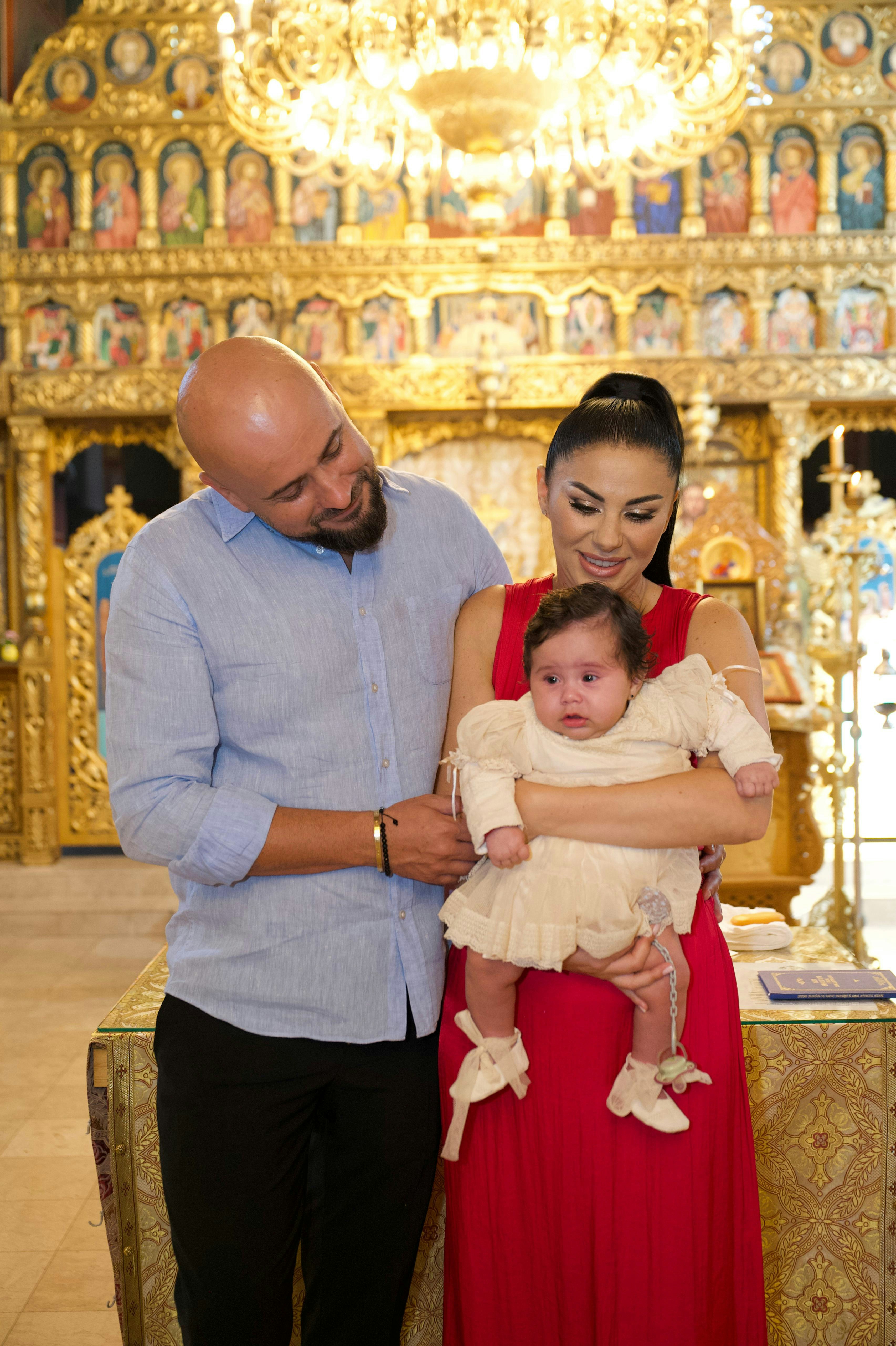 Parents holding baby in a church