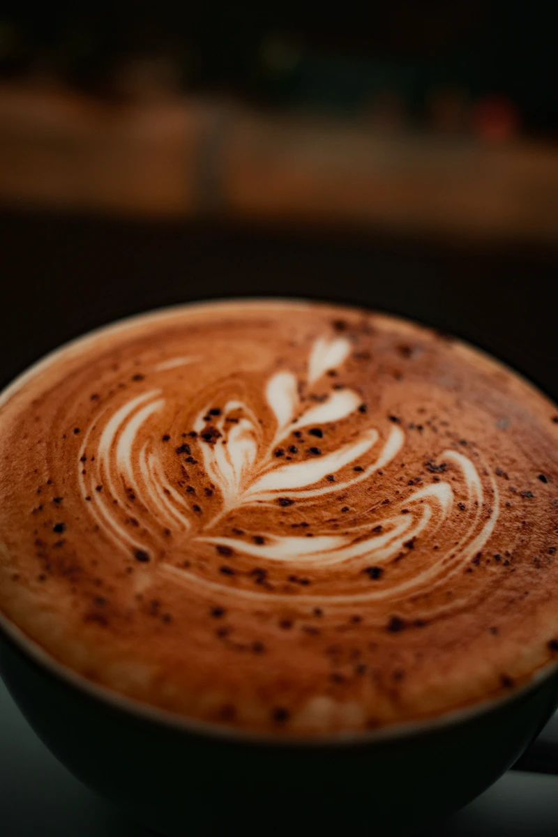 Close-up of decorative latte art in a ceramic cup