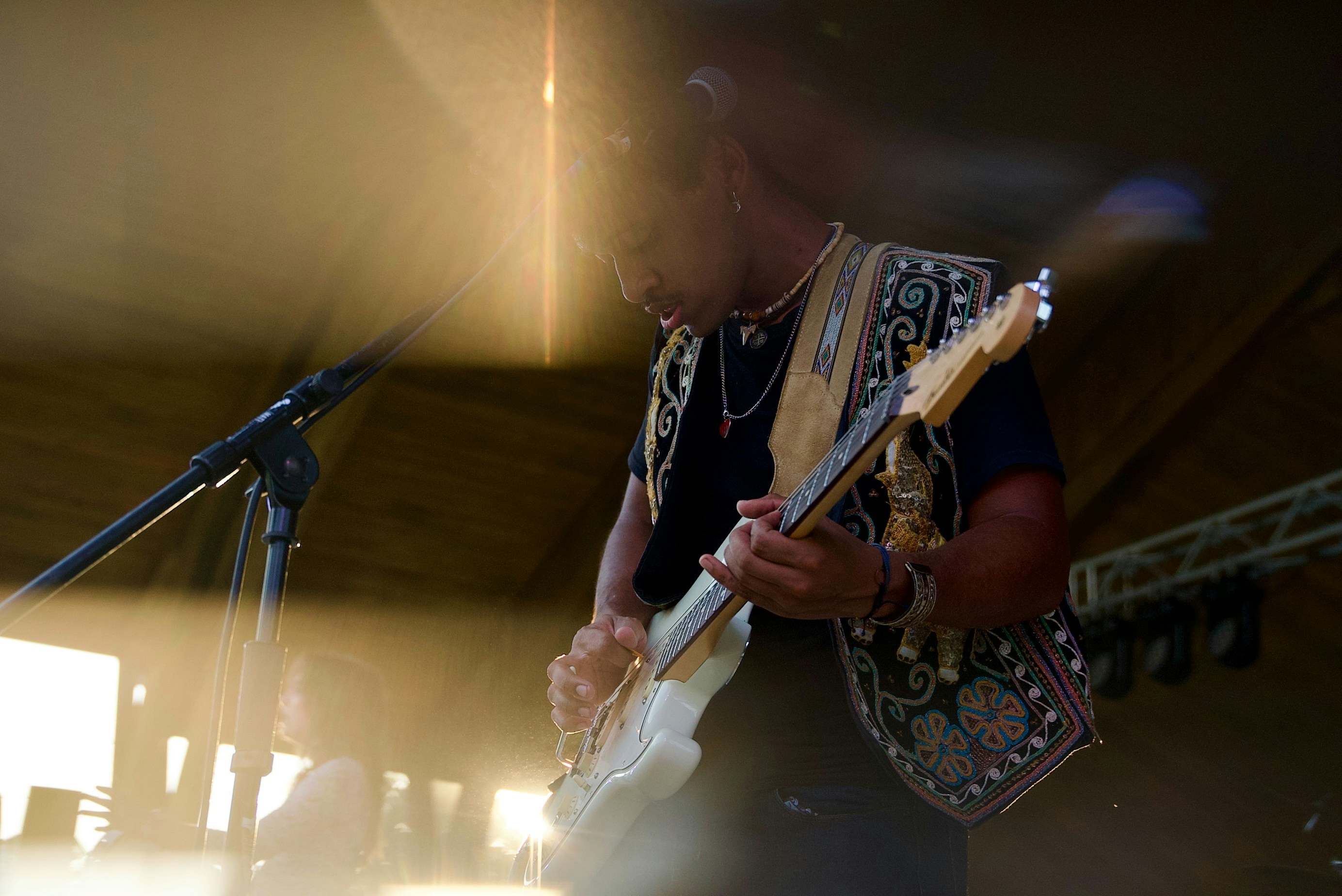 A person playing a guitar on stage.