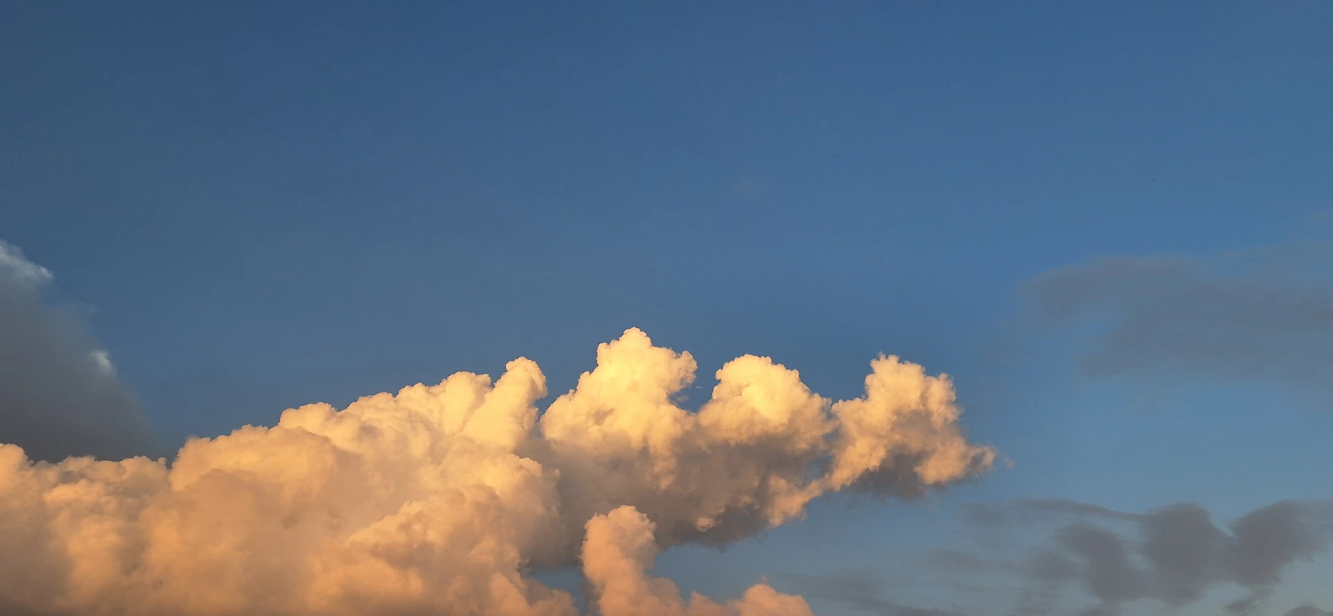 Golden clouds against a blue sky at sunset.