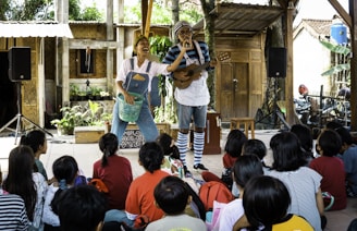 Performers entertain children with music and laughter.