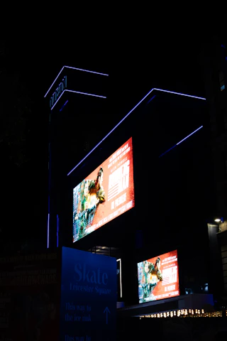 Modern building with illuminated screens at night