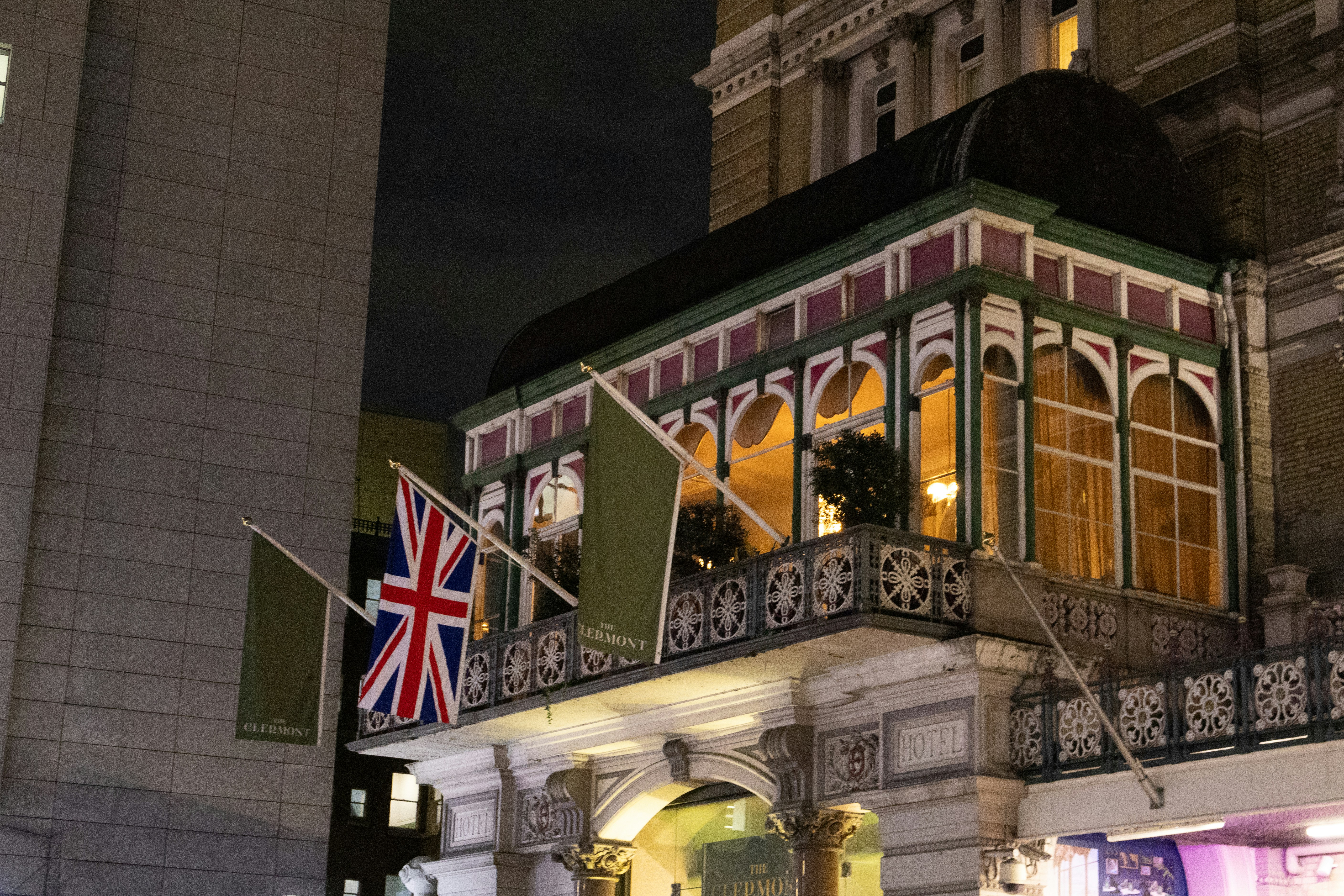 Ornate balcony with union jack flag at night
