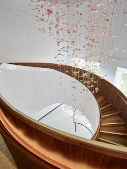 Spiral staircase with a delicate mobile overhead