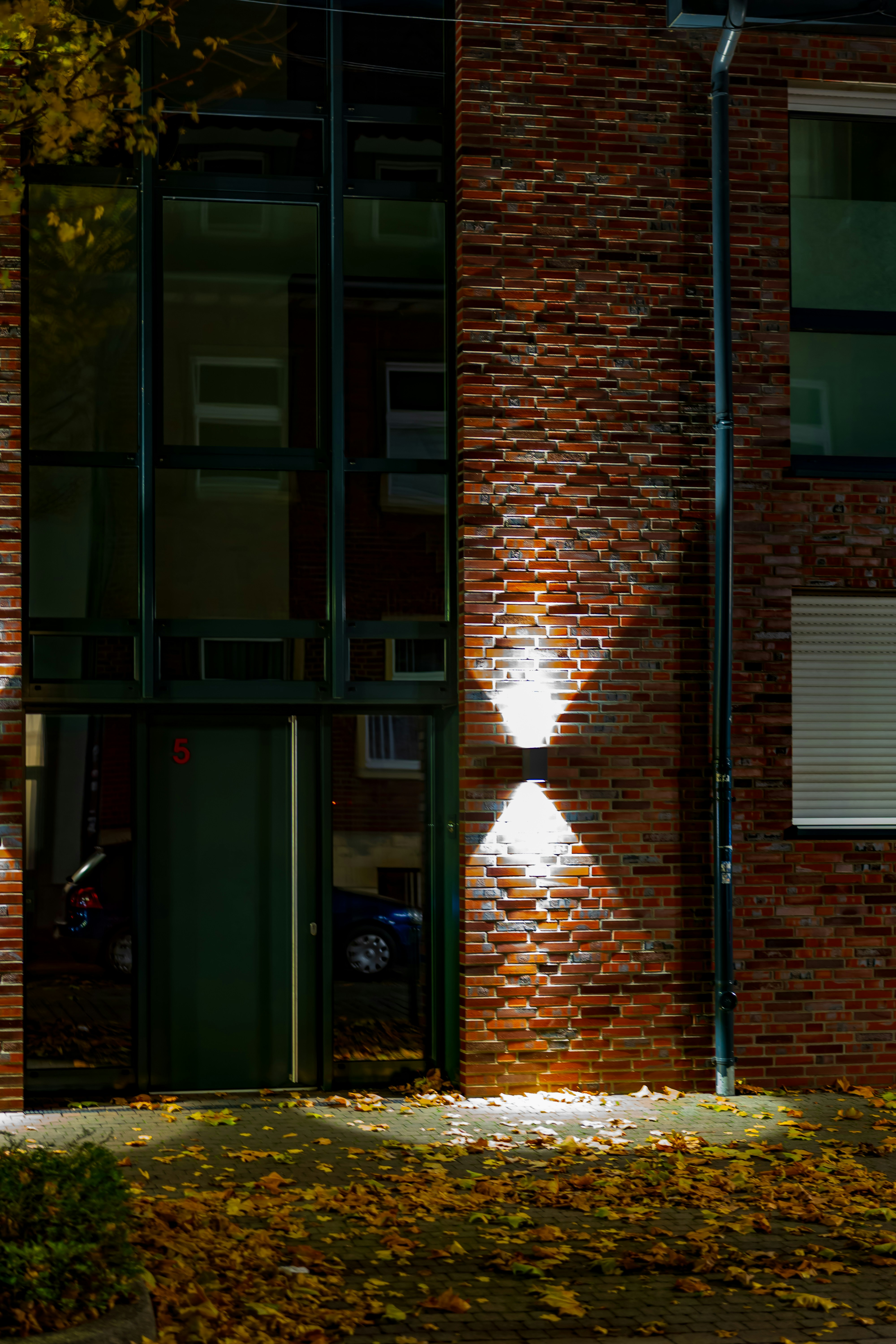 Modern building entrance with brick facade and lights