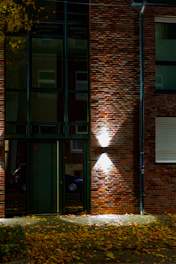 Modern building entrance with brick facade and lights