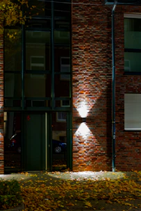 Modern building entrance with brick facade and lights
