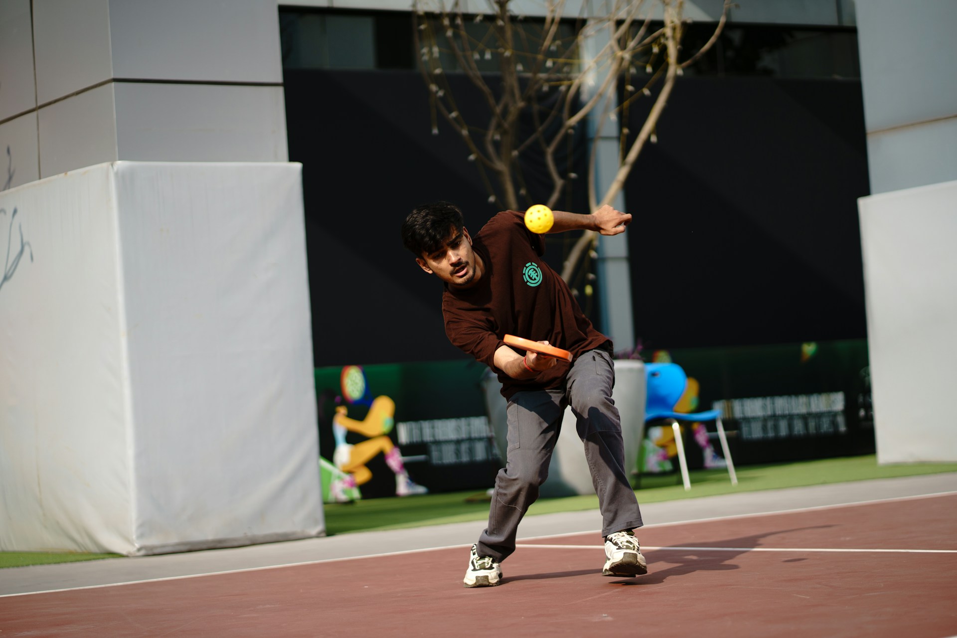 Man juggling balls outdoors with blurred background