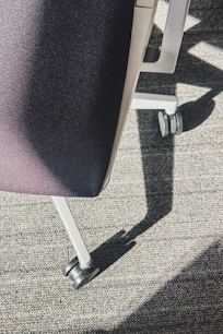 Close-up of a rolling office chair on carpet