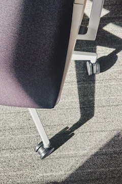 Close-up of a rolling office chair on carpet
