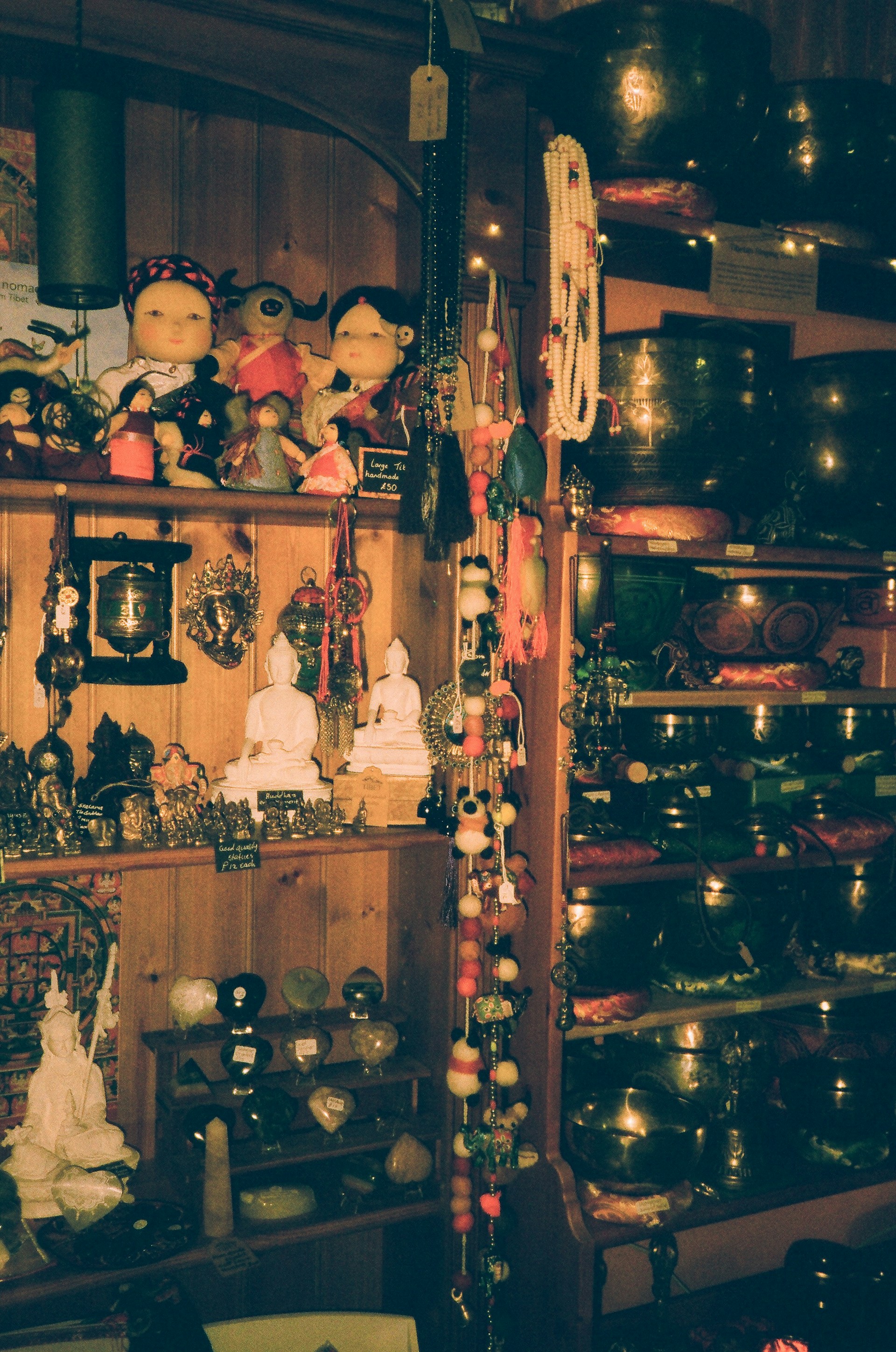 Various spiritual items displayed on wooden shelves.