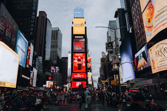 Times square with bright billboards and crowds below people