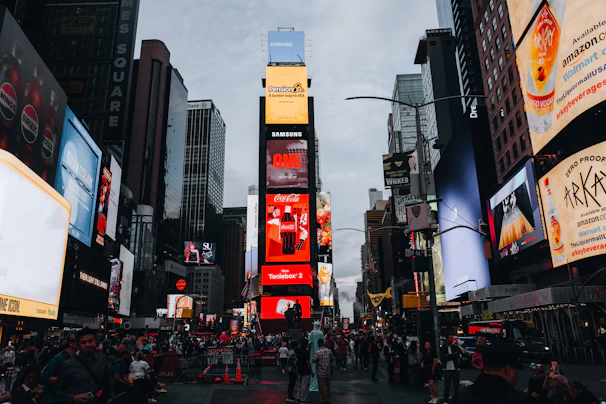 Times square with bright billboards and crowds below people