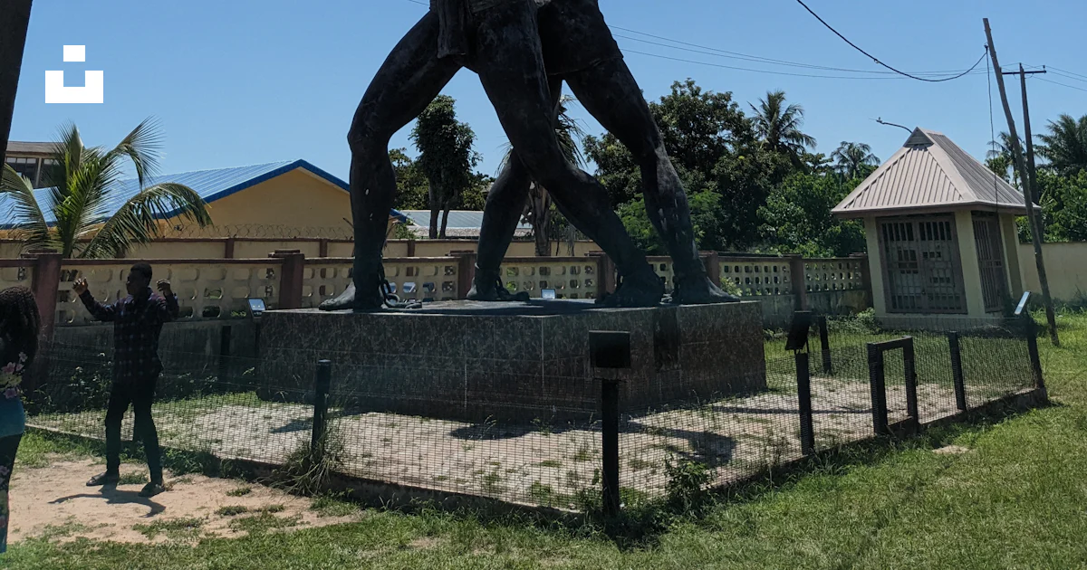 Chained Statue Statue of two men breaking chains under a clear sky photo – Free ...