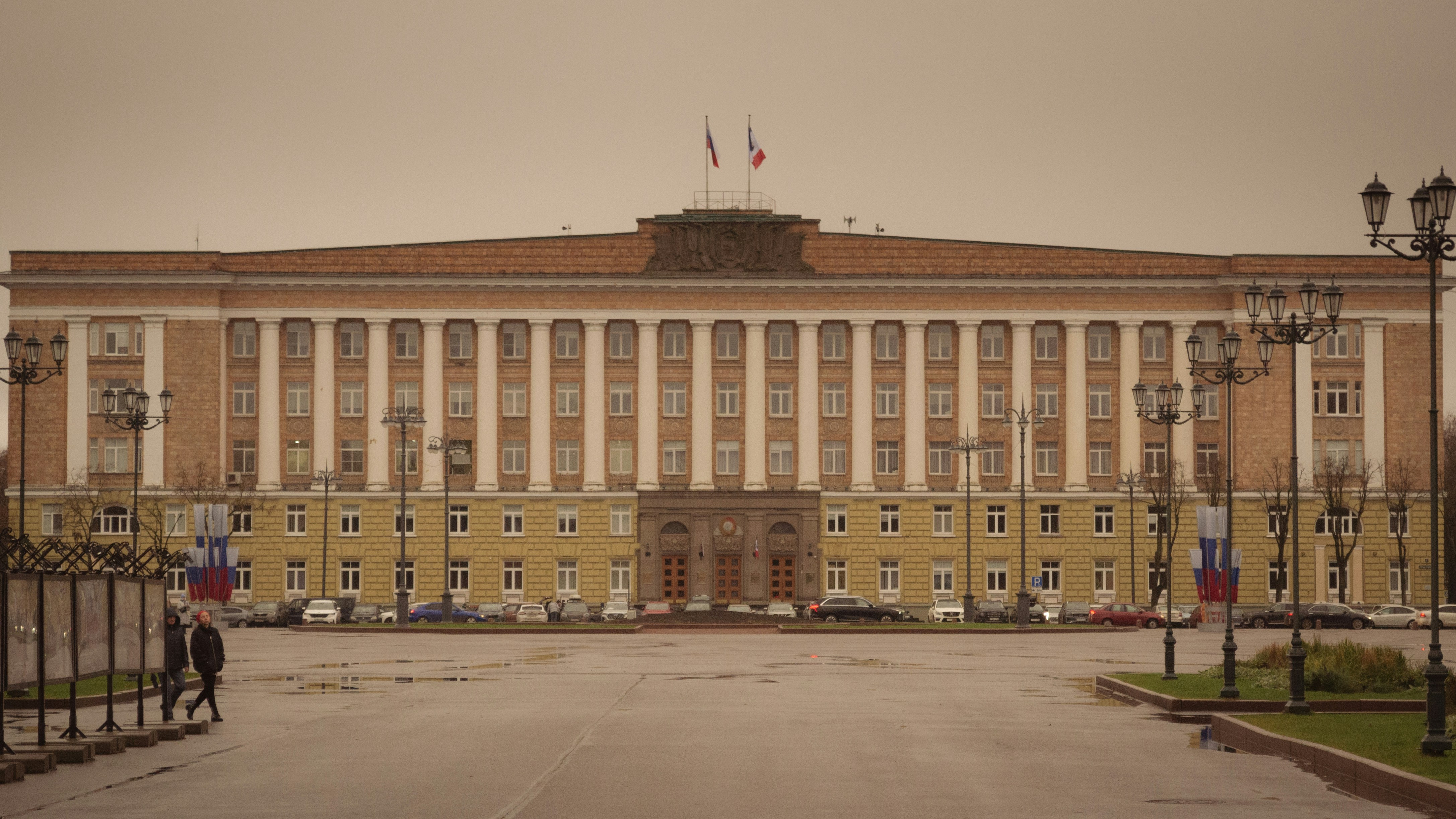 Grand building with columns under cloudy sky