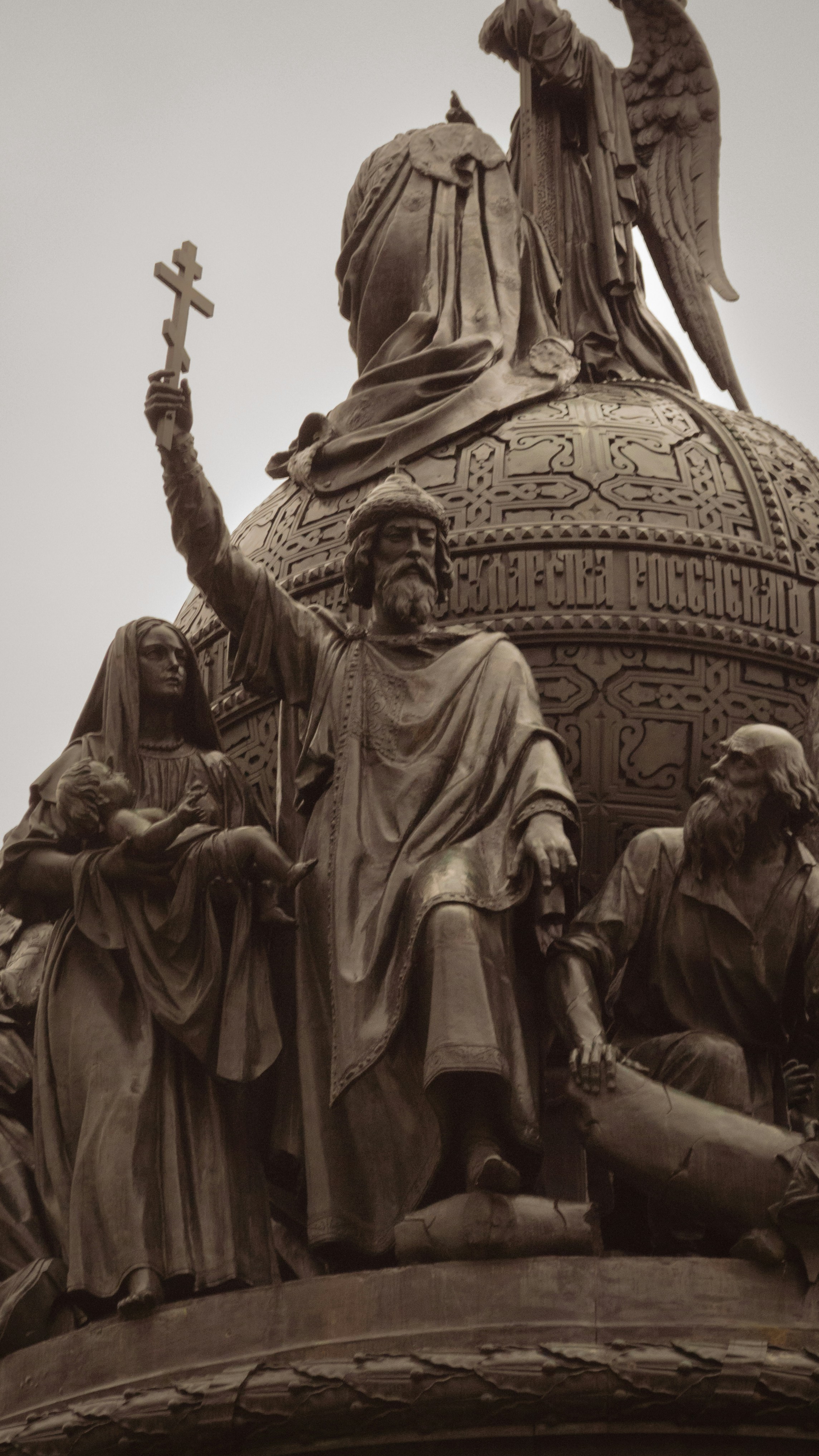 Bronze monument with figures and a cross