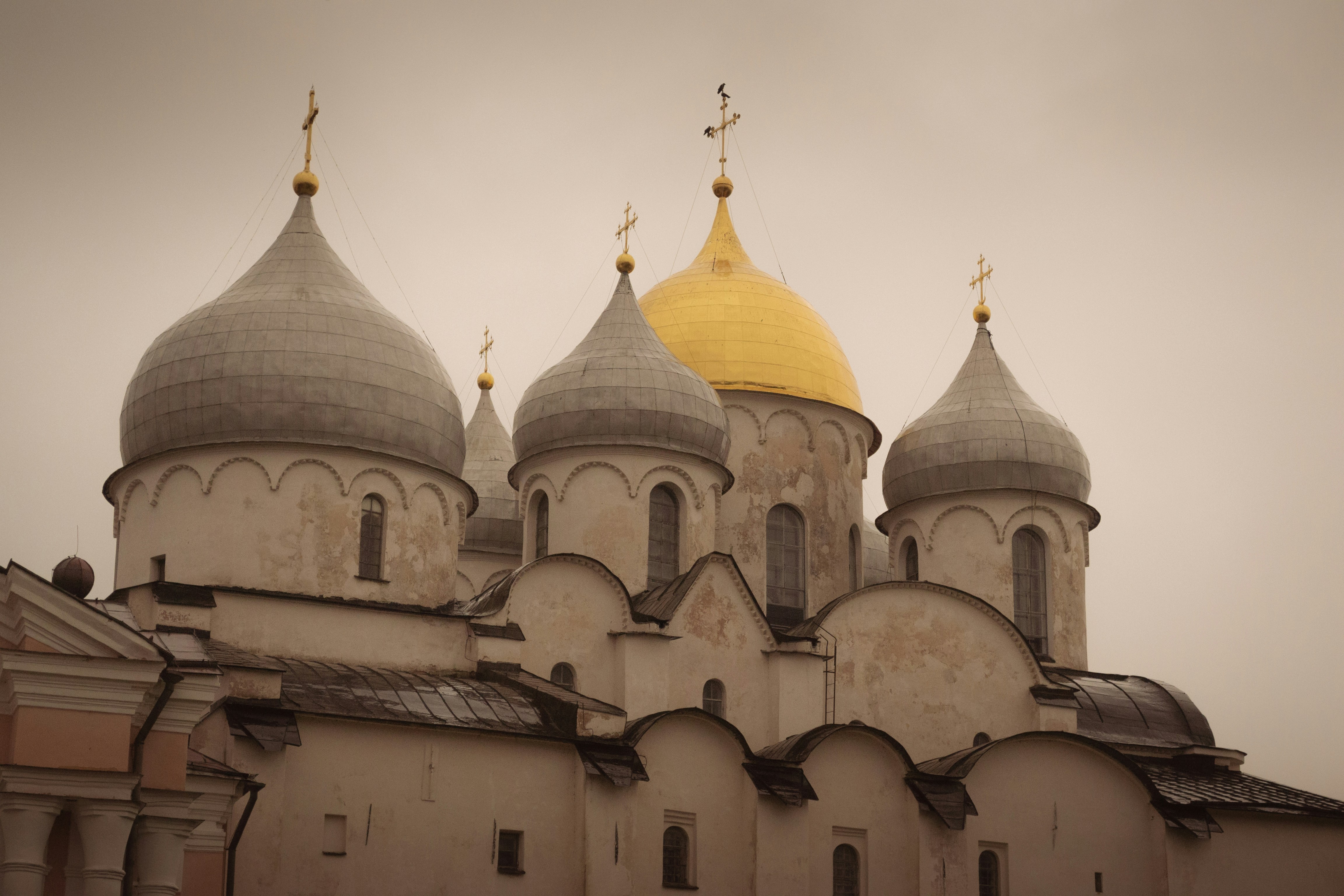 Ornate cathedral with multiple domes under a cloudy sky
