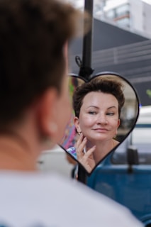 Woman looking in heart-shaped mirror