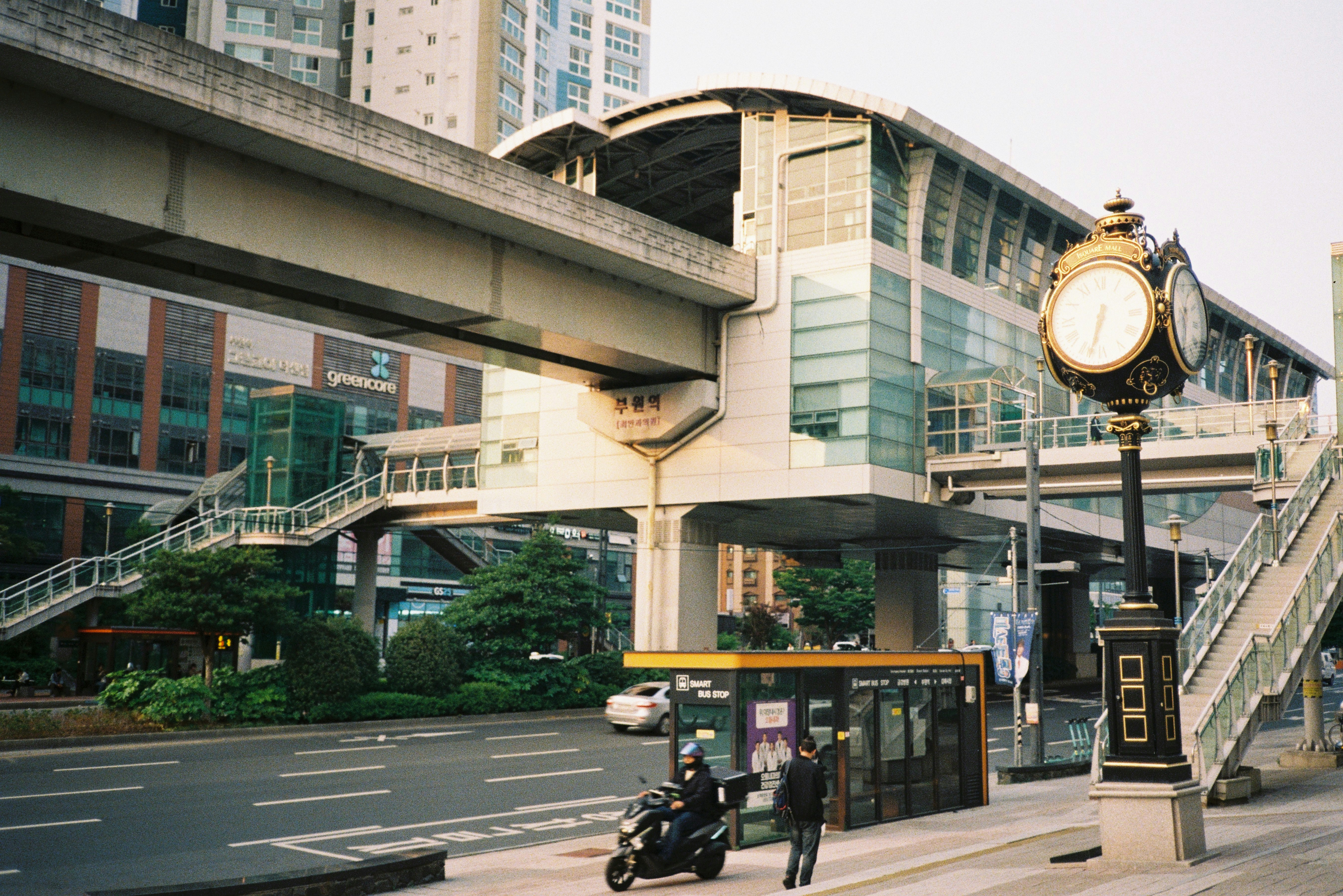 Modern elevated train station with clock tower clock
