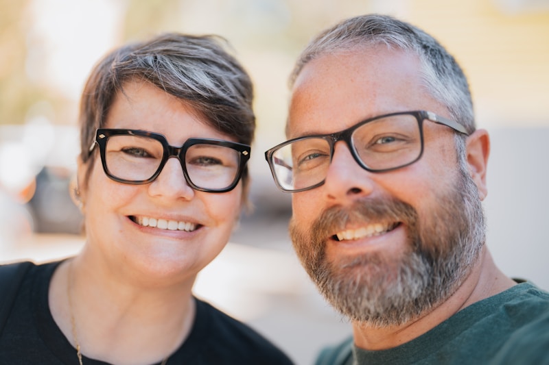 stylish couple wearing glasses at outdoor event