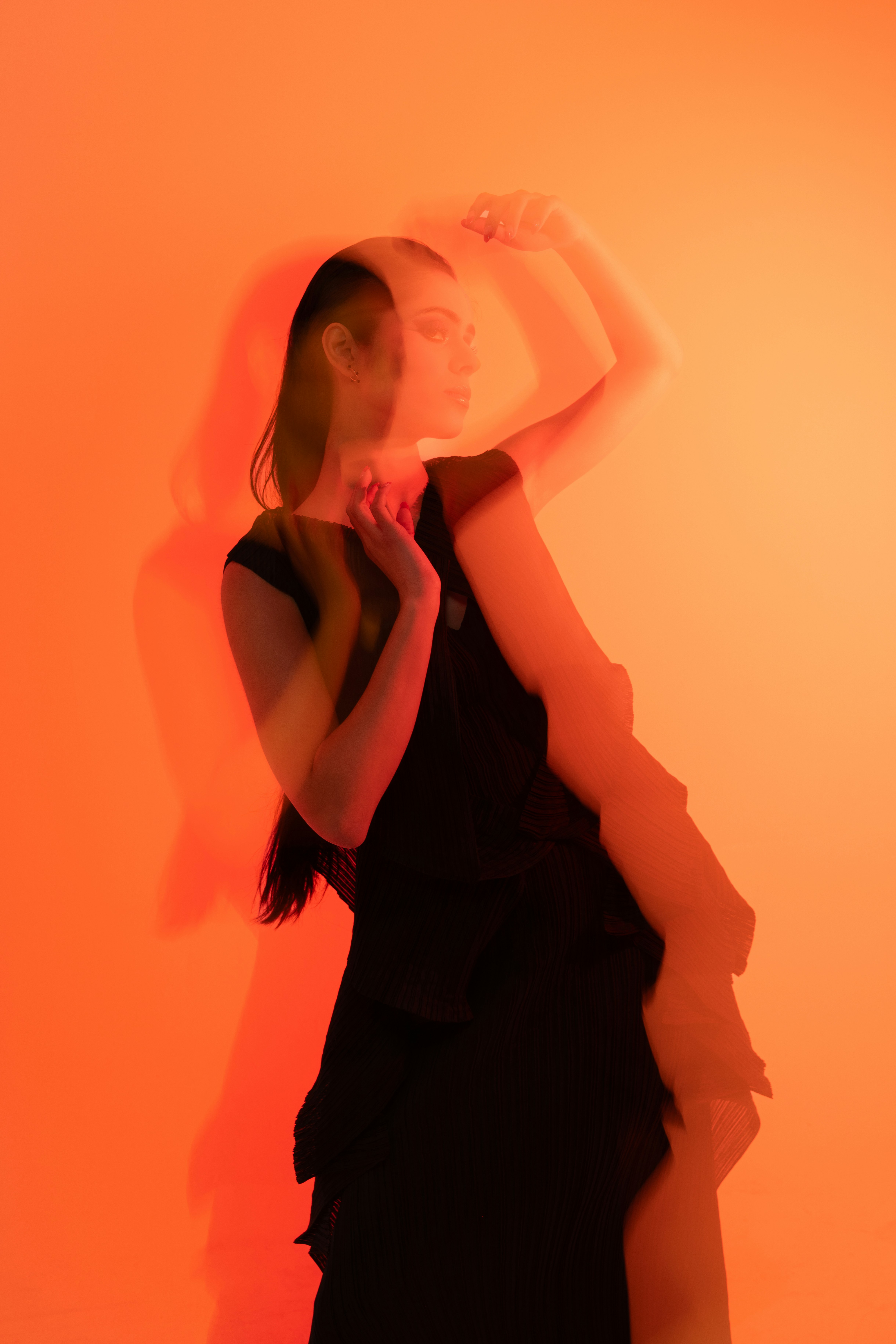 Woman in black dress with orange light effect