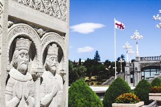 Stone carvings of kings with georgian flag flying
