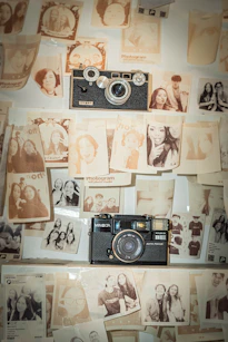 Two vintage cameras displayed with photographs