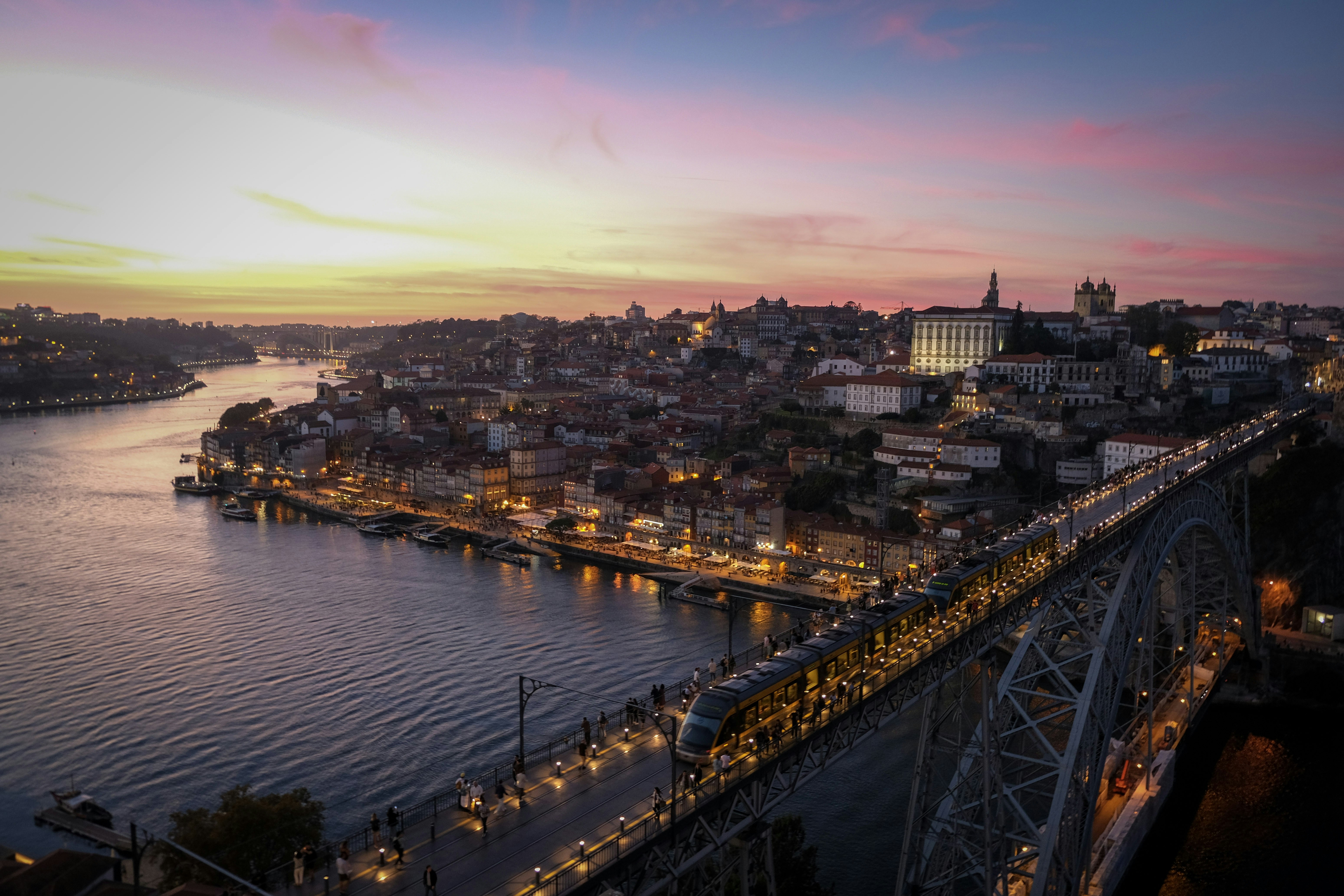 Cityscape with bridge and river at sunset