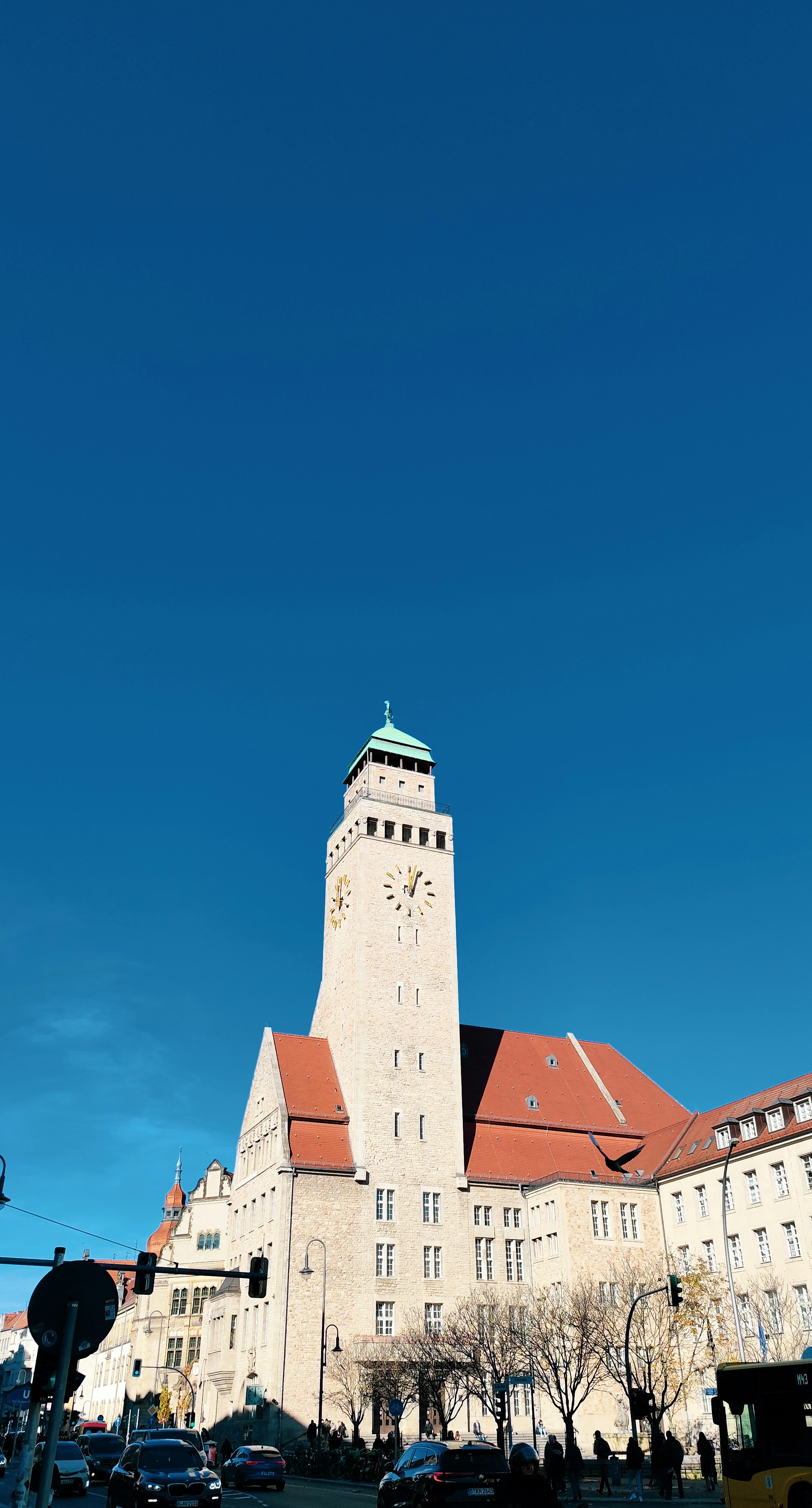 A tall clock tower building under a clear blue sky.
