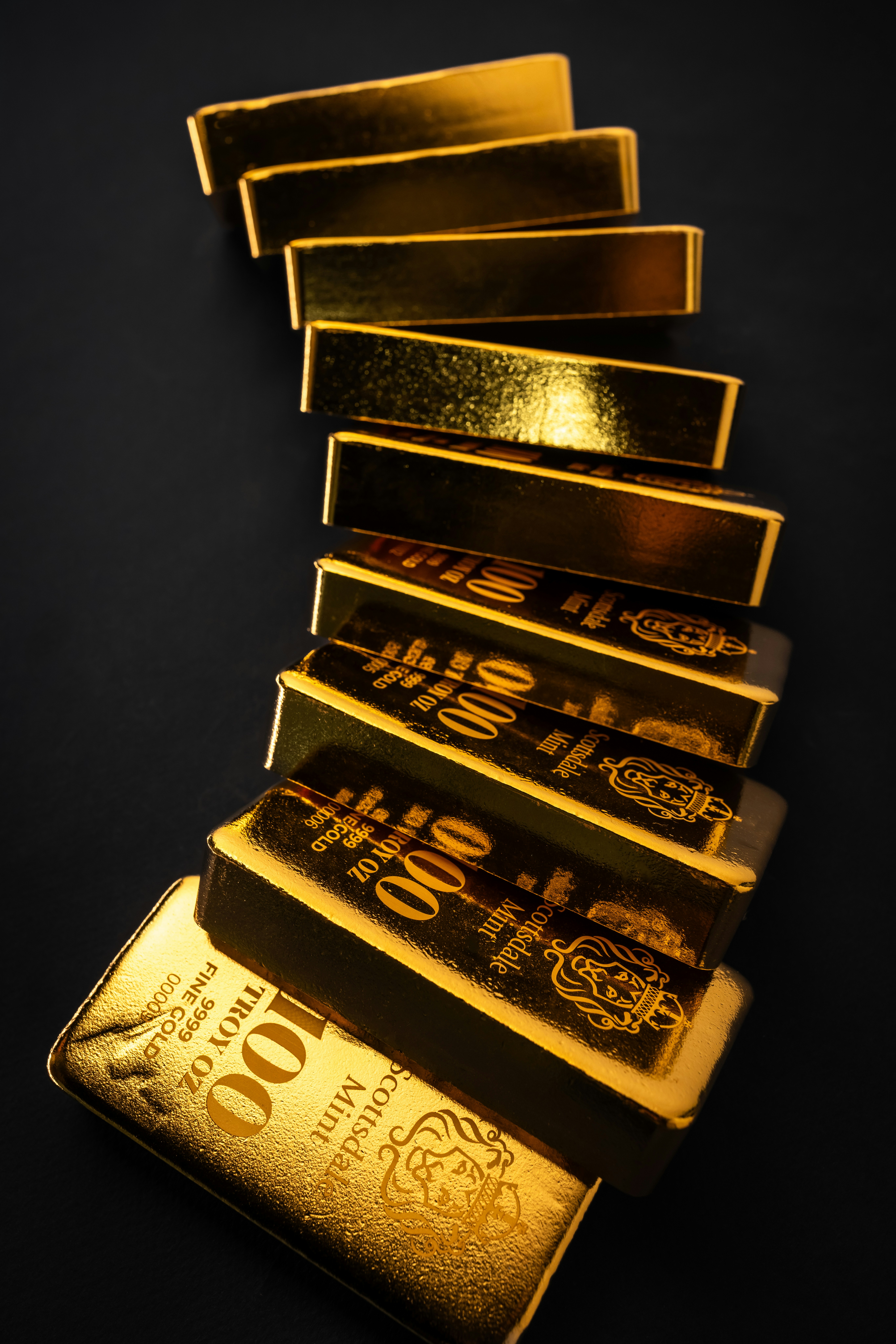 Beautiful 100 Troy Ounce Gold Bullion Bar by Scottsdale Mint sitting on a dark background. Please give a shoutout to Scottsdale Mint if able! Shop online for the most beautiful bullion at ScottsdaleMint.com!