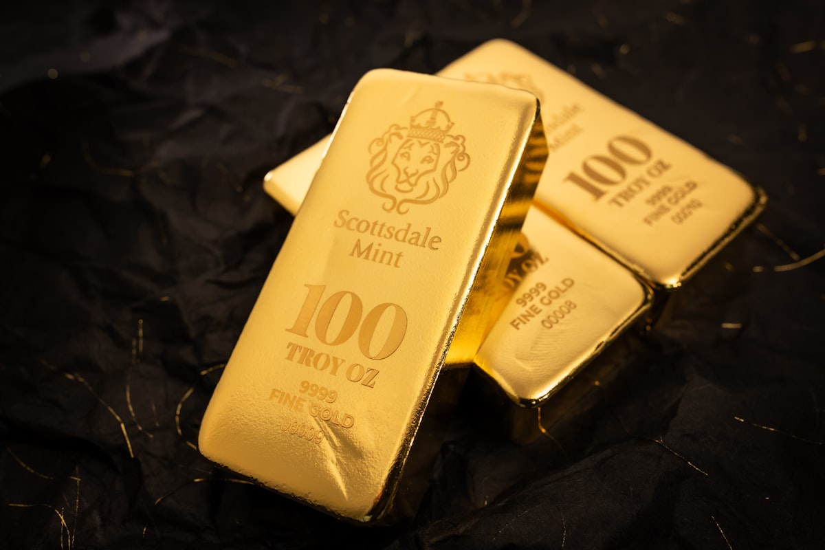 Gold bullion bars stacked on a dark surface representing the precious metals market and central bank reserves
